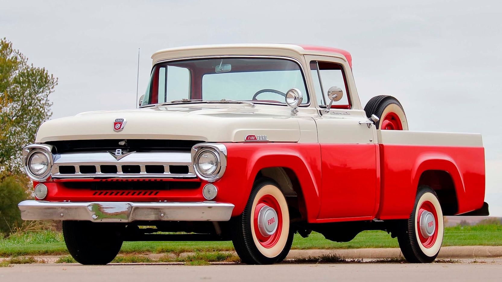 A parked red and white Ford F100