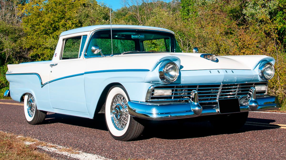 A parked baby blue 1957 Ford Ranchero
