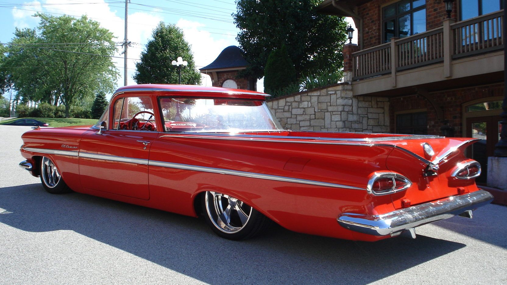 A parked red 1959 Chevy El Camino