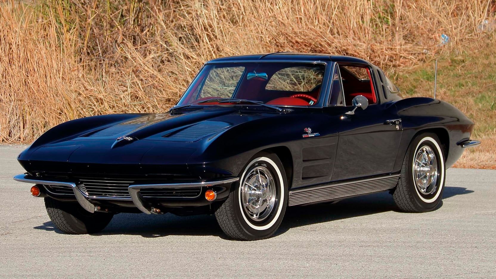 A parked black 1963 Chevy Corvette