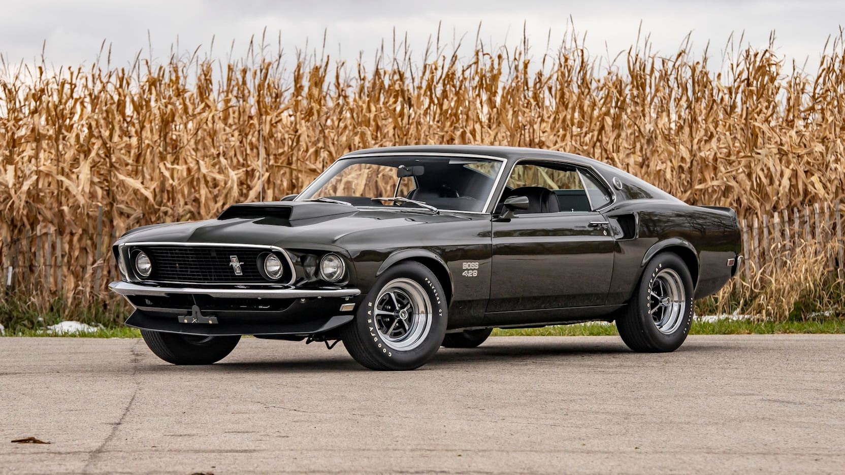 A parked black 1969 Ford Mustang Boss 429 Fastback