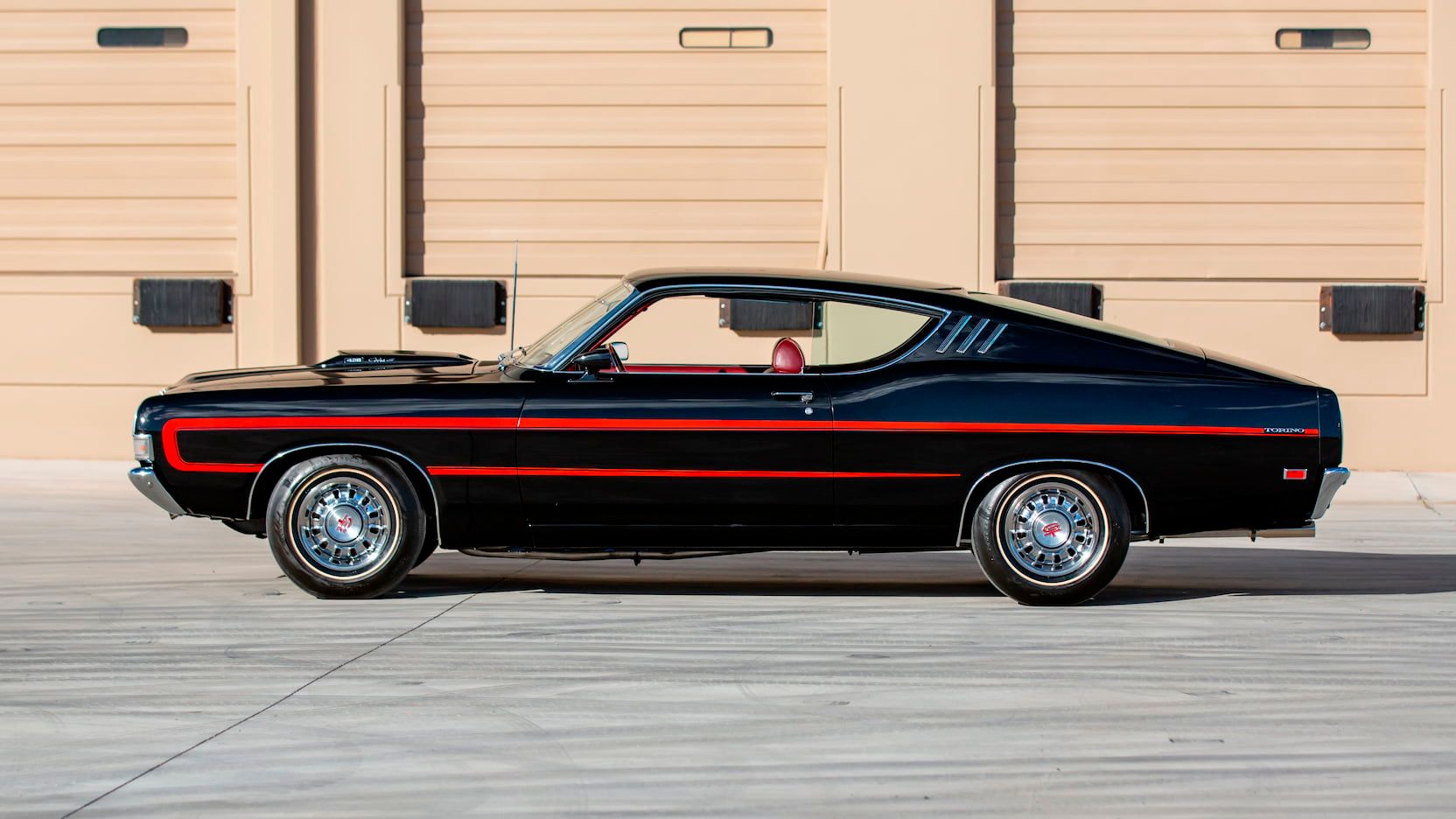 A parked black and red 1969 Ford Torino GT