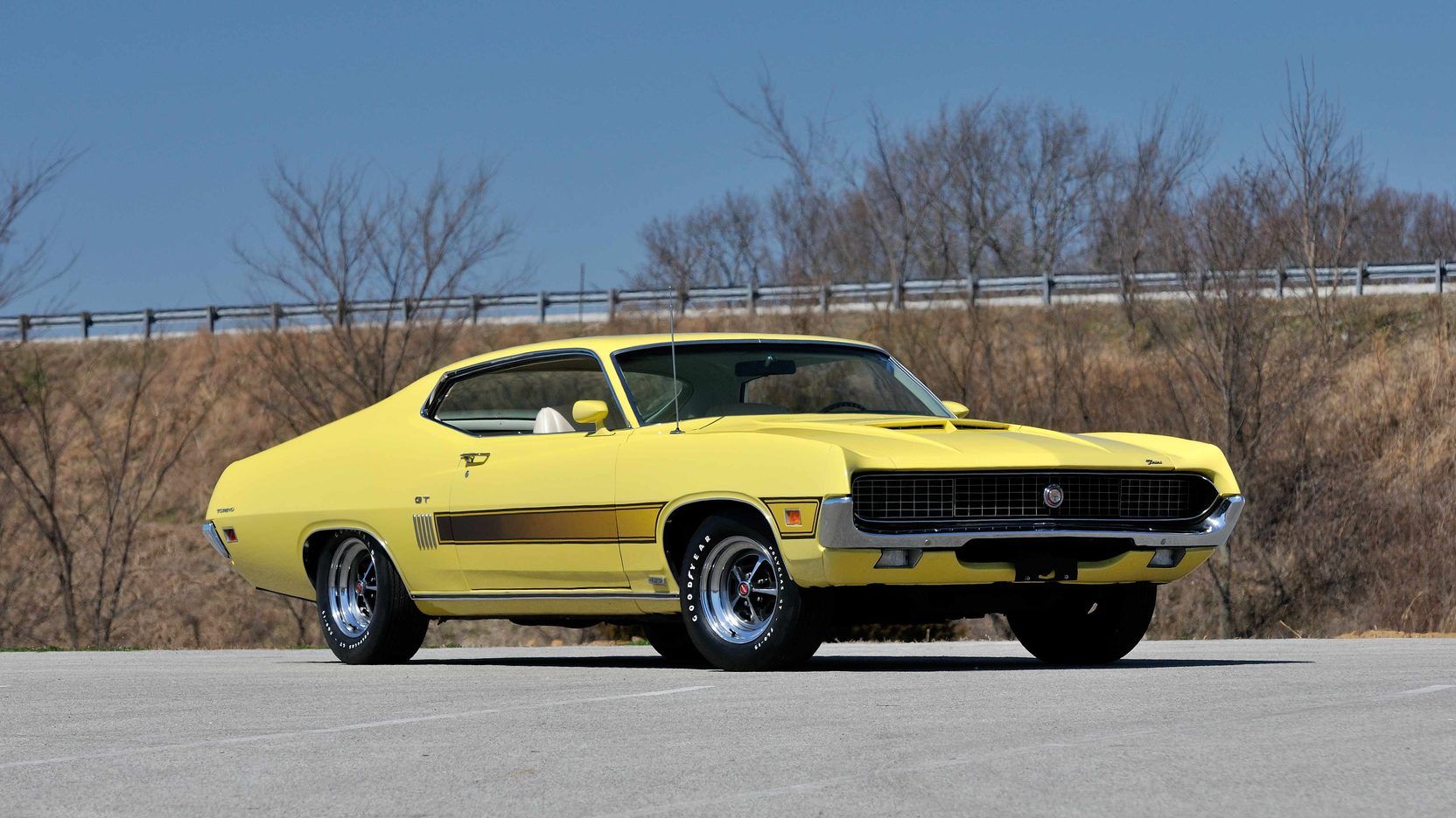 A parked yellow 1970 Ford Torino GT