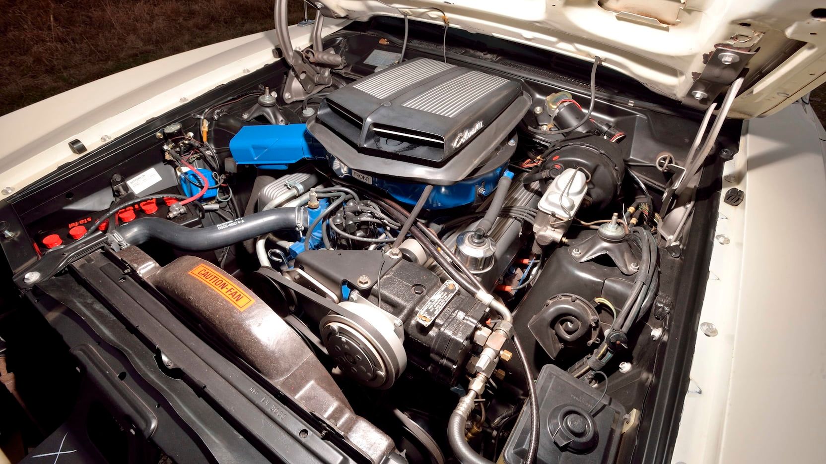 A parked 1970 Ford Torino GT convertible engine bay