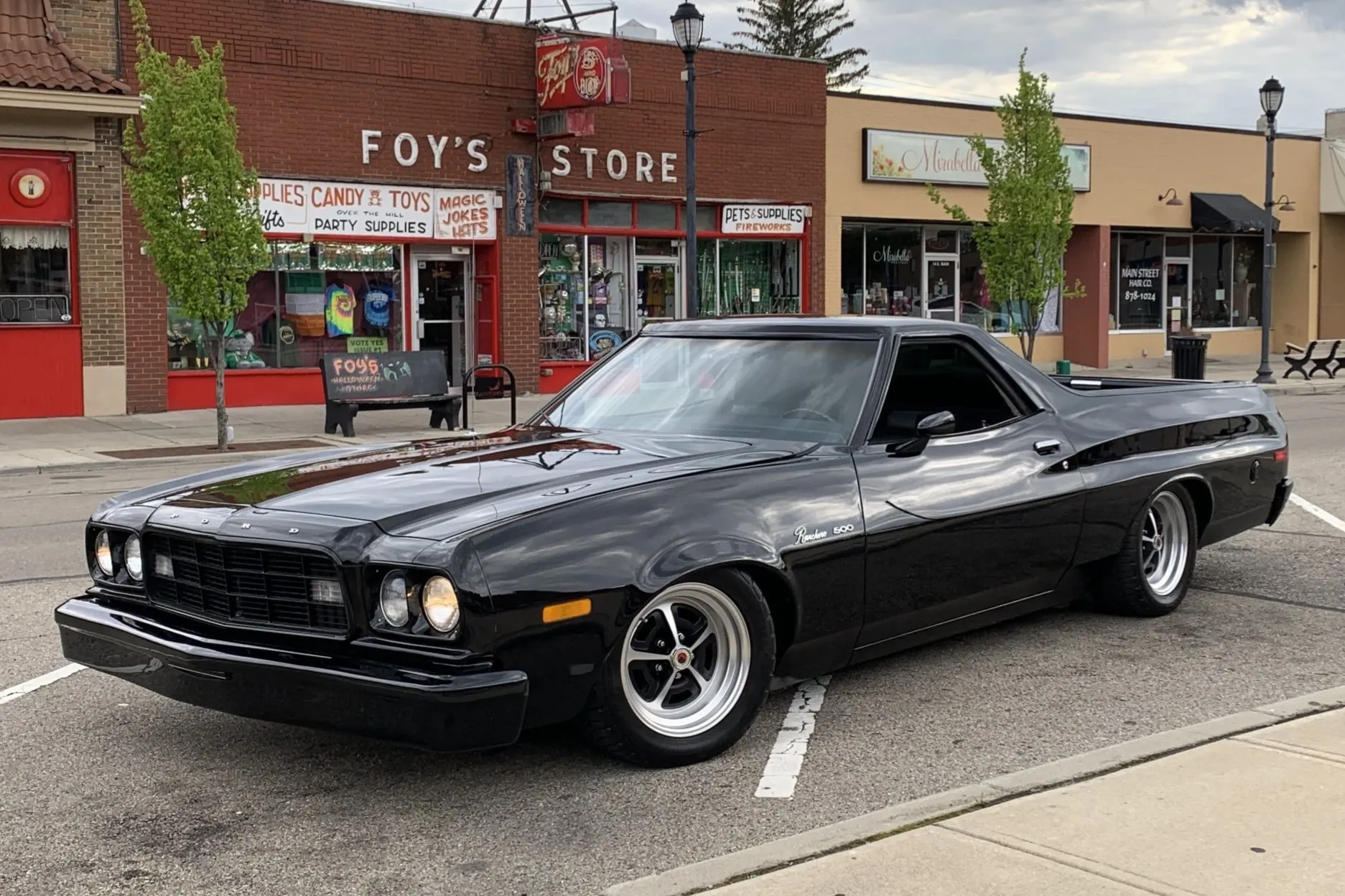 A parked black 1973 Ford Ranchero 500