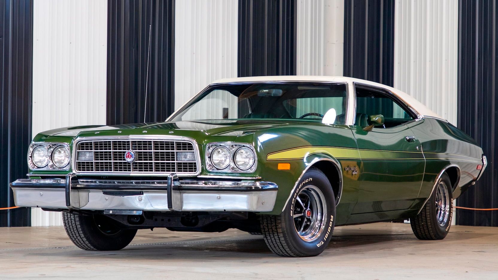 A parked green 1973 Ford Grand Torino Sport