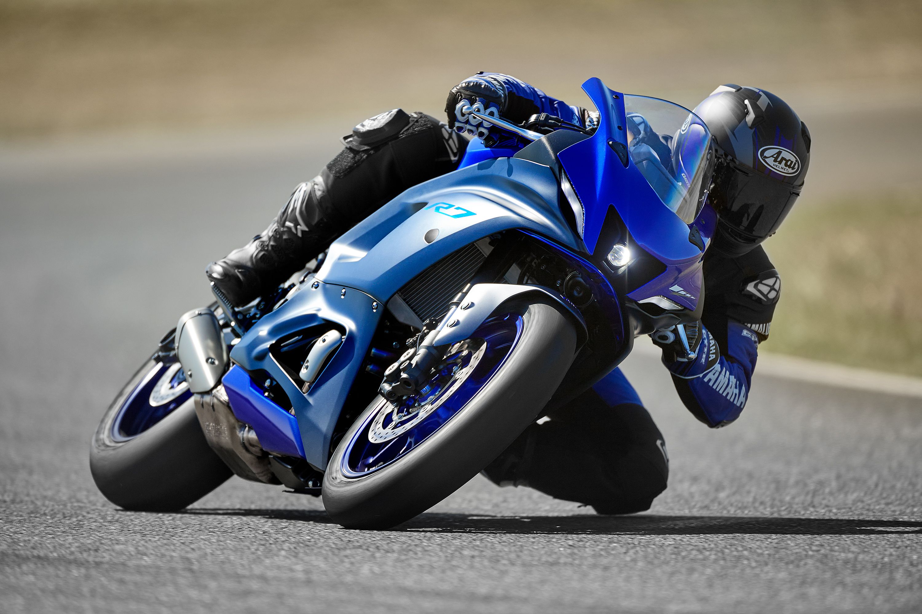Blue 2022 Yamaha YZF-R7 in a curve