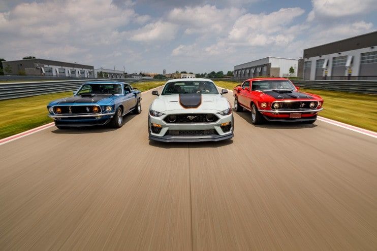 Three moving Mustangs 