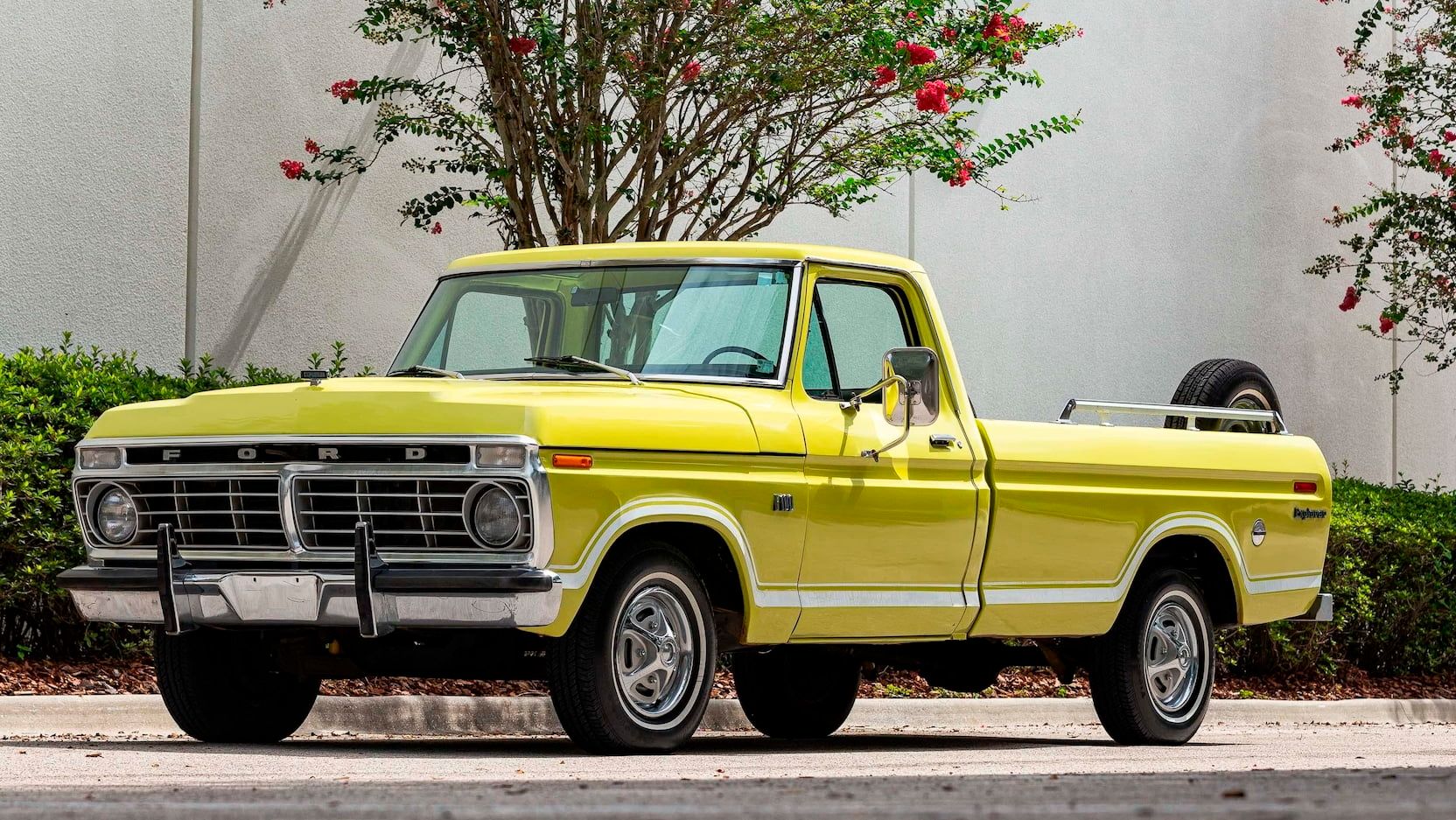A parked yellow 1973 Ford F100 Explorer