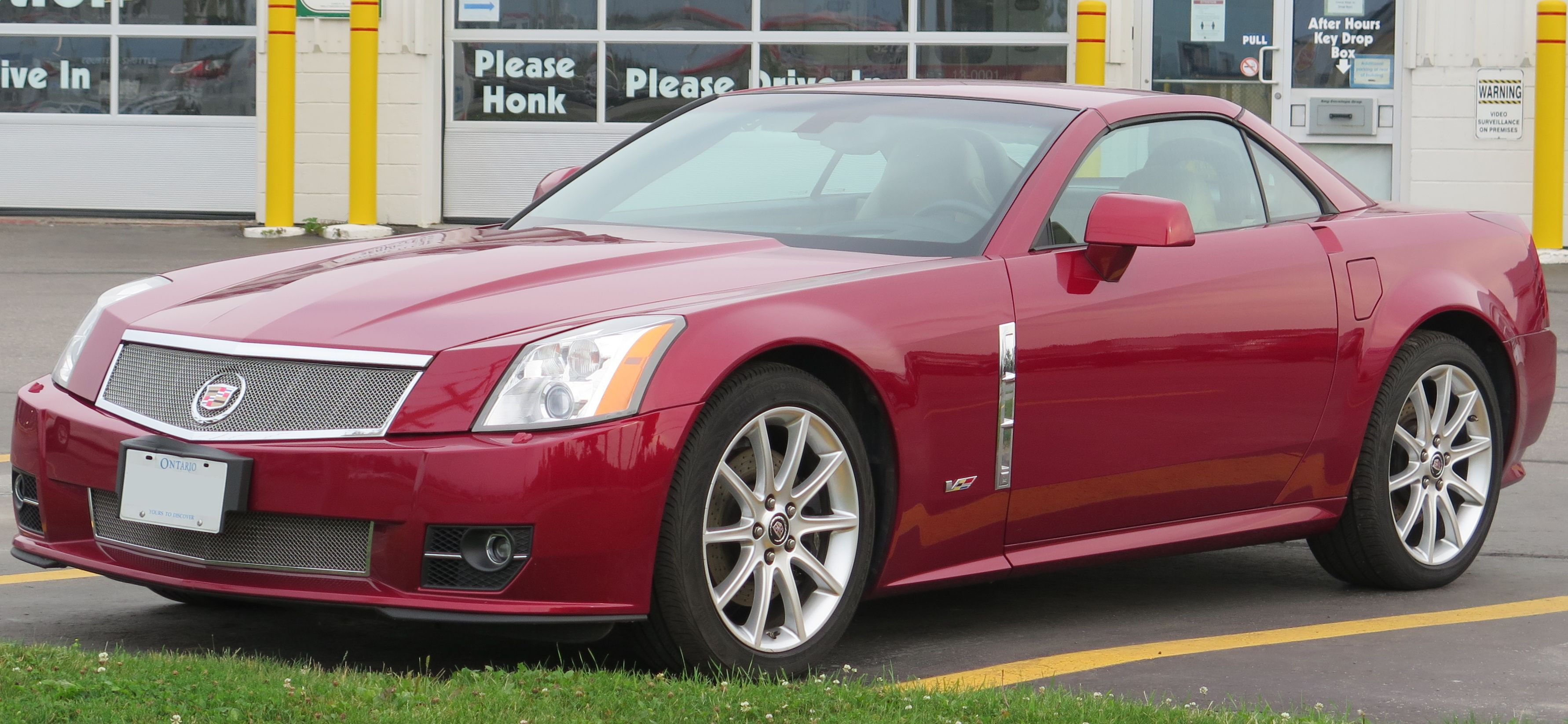 2009 Cadillac XLR-V red parked outside