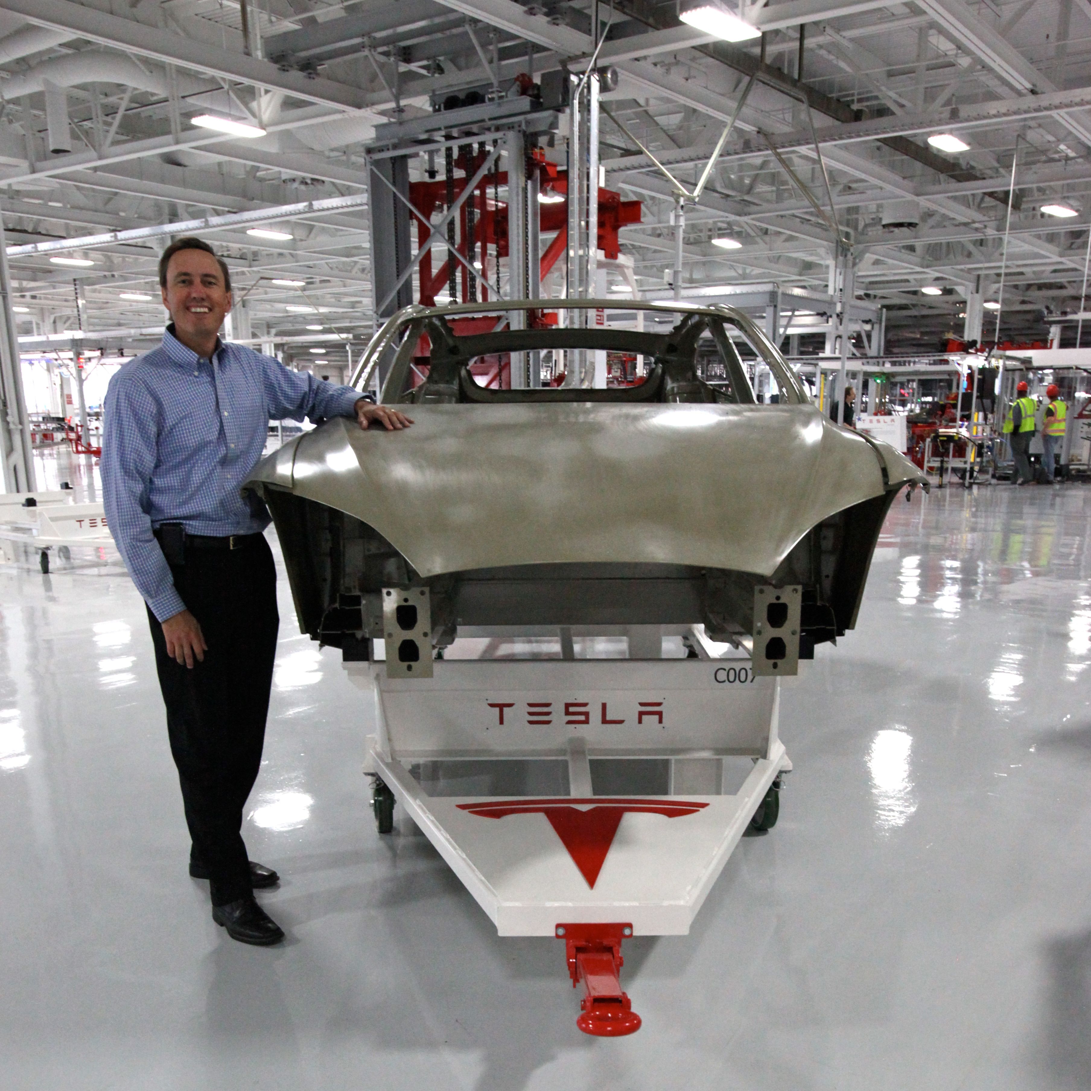 Tesla factory floor interior in front of car