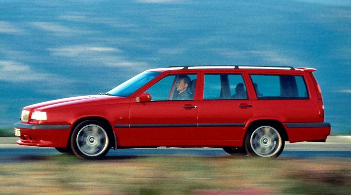 Red 1994 Volvo 850 Turbo wagon driving.