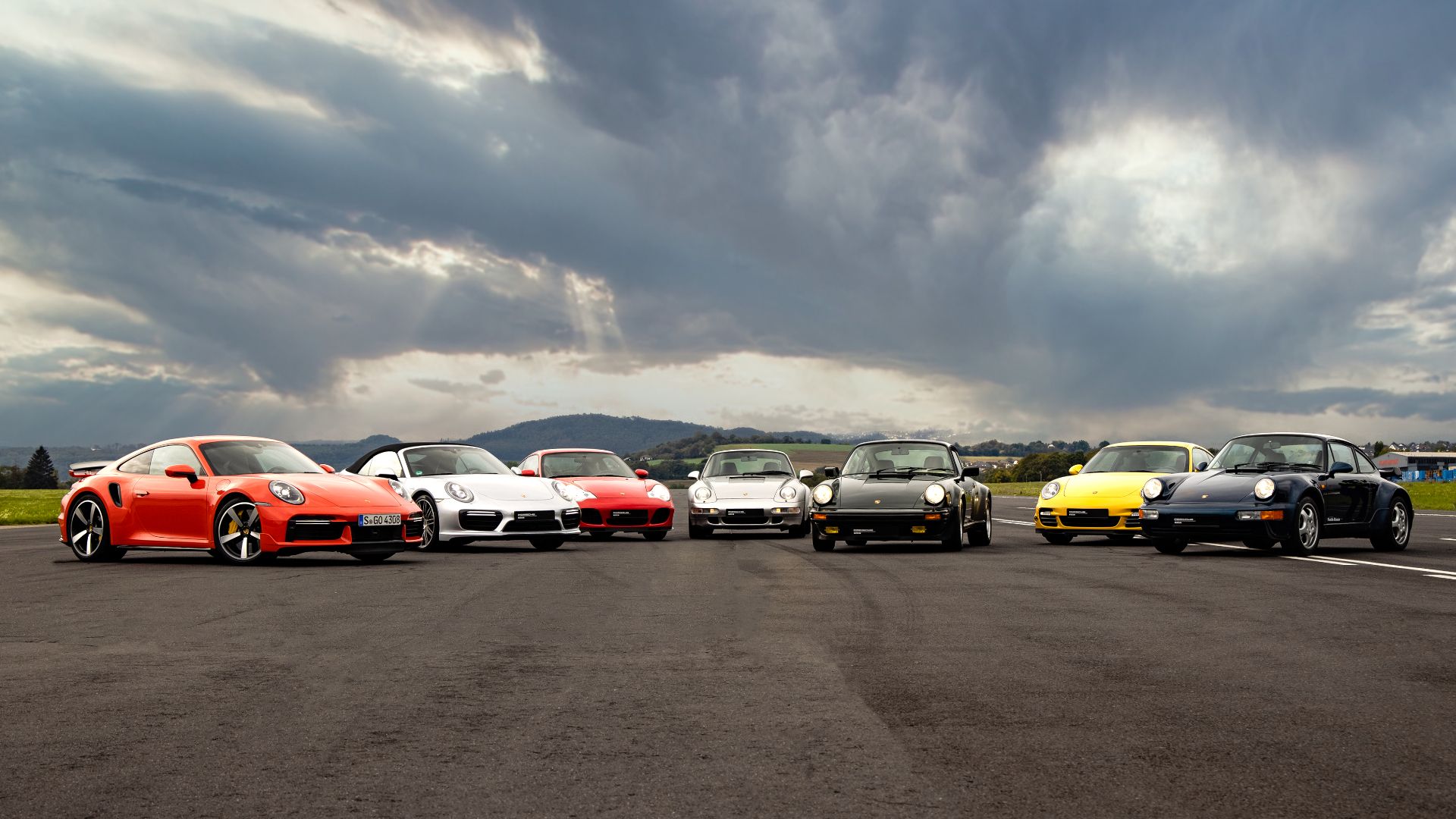A group shot of several Porsche 911 Turbo generations