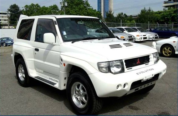 A white 1998 Mitsubishi Pajero Evolution is parked.