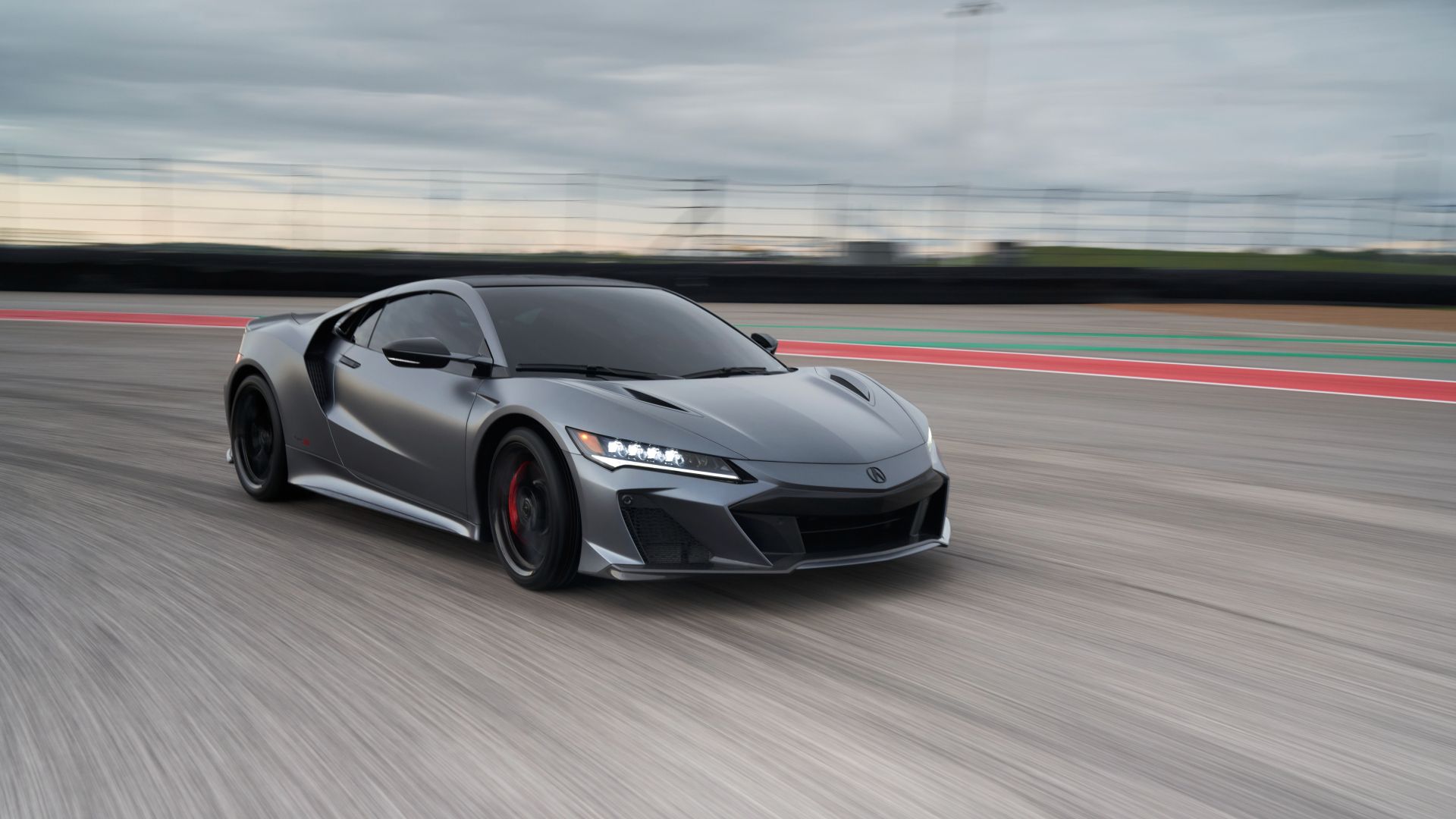 A front shot of a silver 2022 Acura NSX Type S driving on track