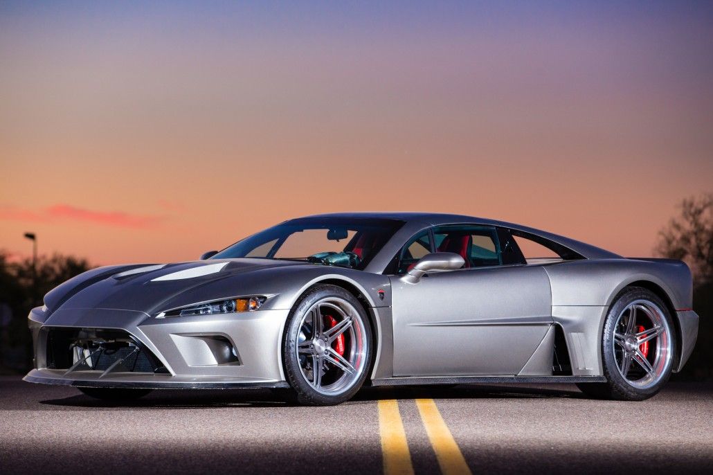 A 3/4 front shot of a grey Falcon F7 on the road