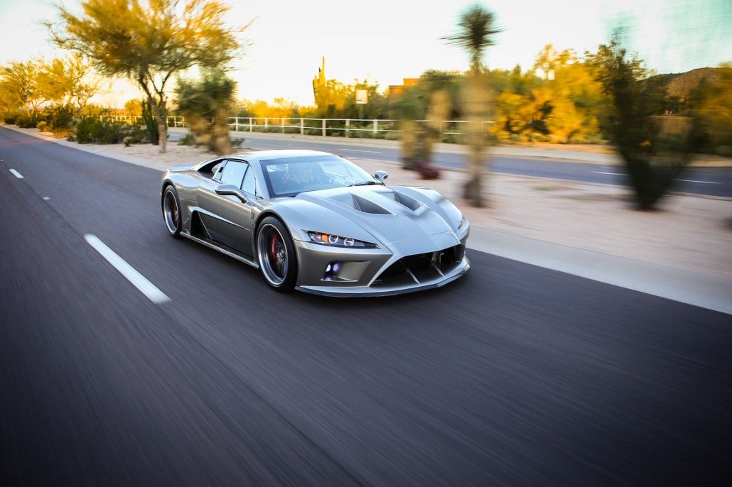 A front action shot of a grey Falcon F7 driving on the road