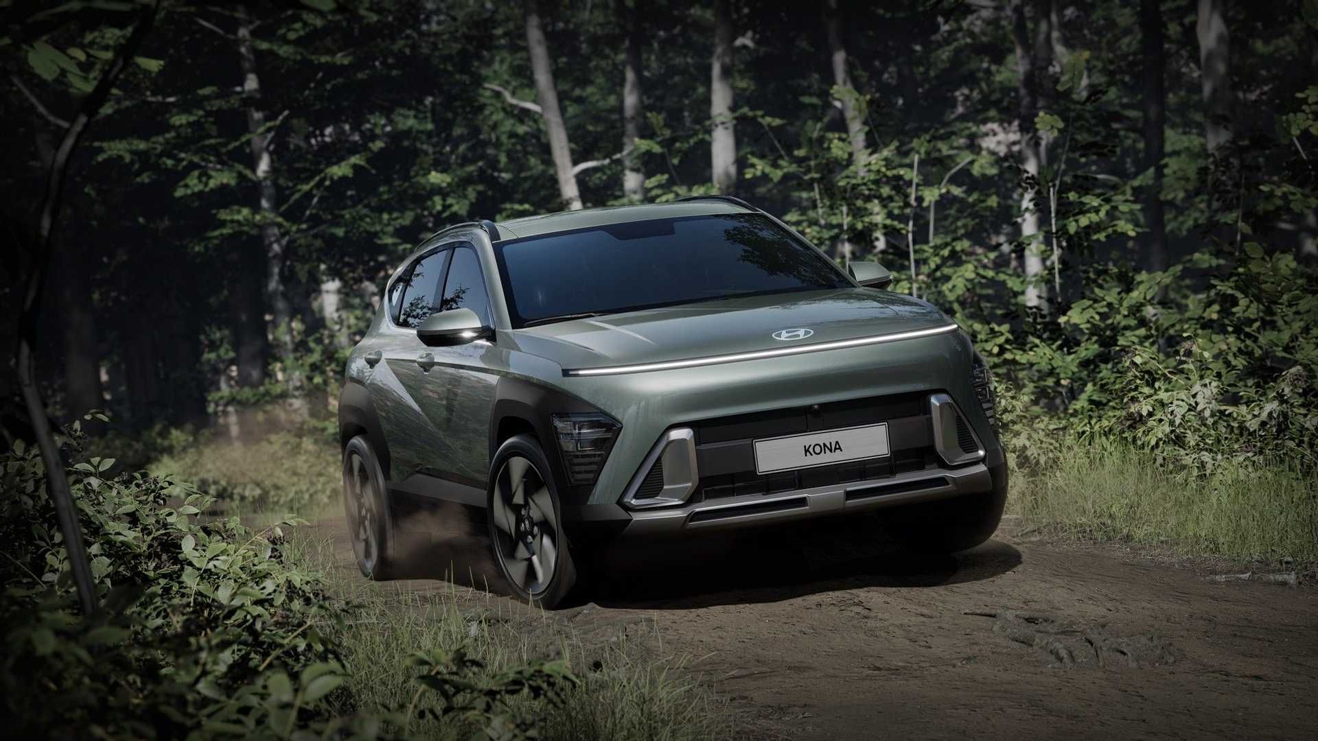 A green 2024 Hyundai Kona driving on dirt.