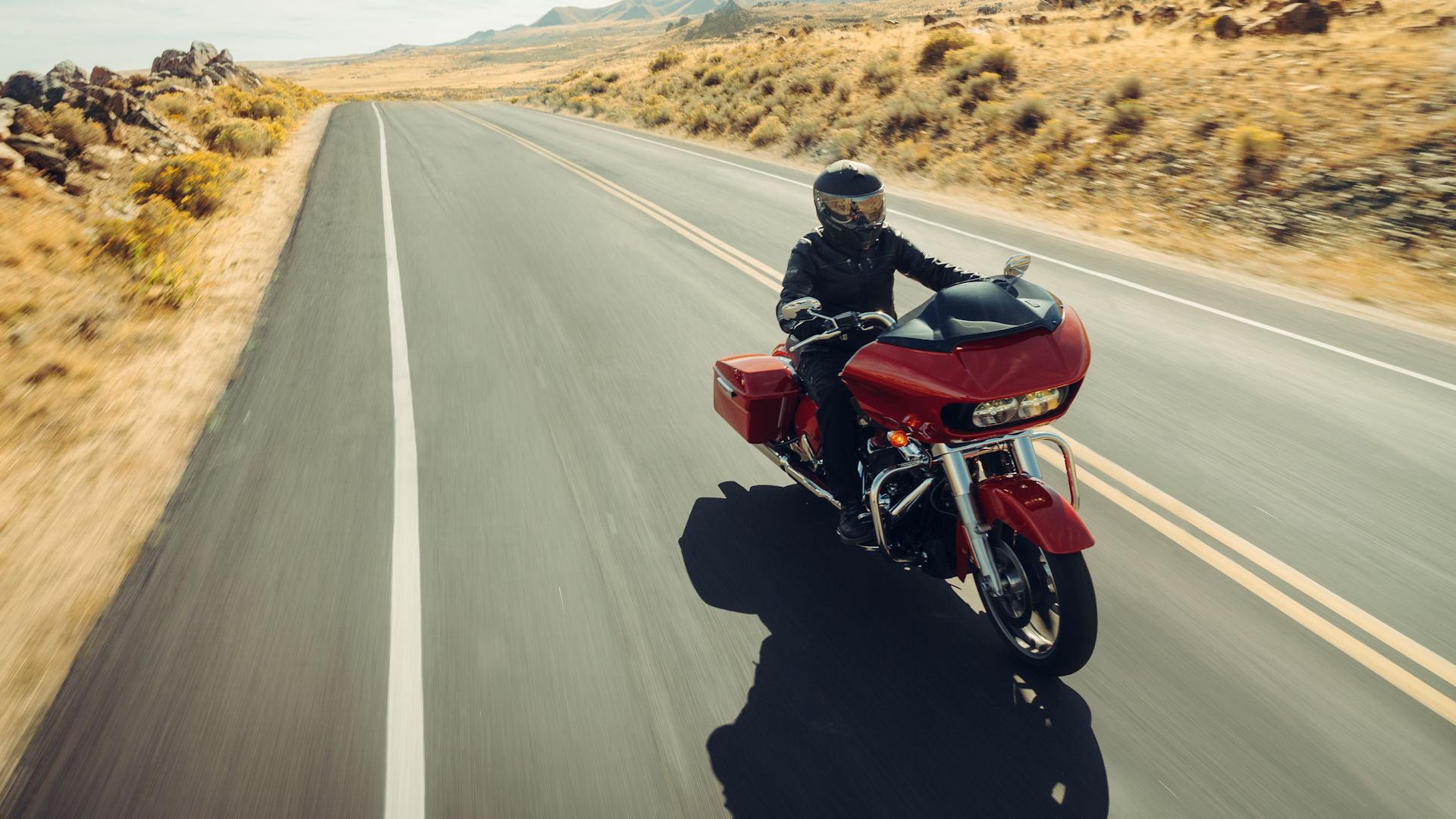Red 2023 Harley-Davidson Road Glide cruising on the highway