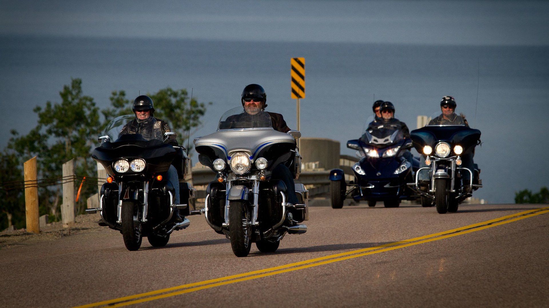 A group of motorcycles riding in a staggered position