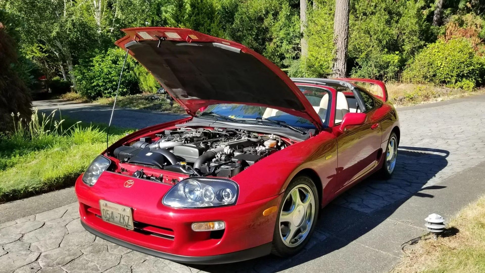 Red 1997 Toyota Supra 2JZ with the hood open