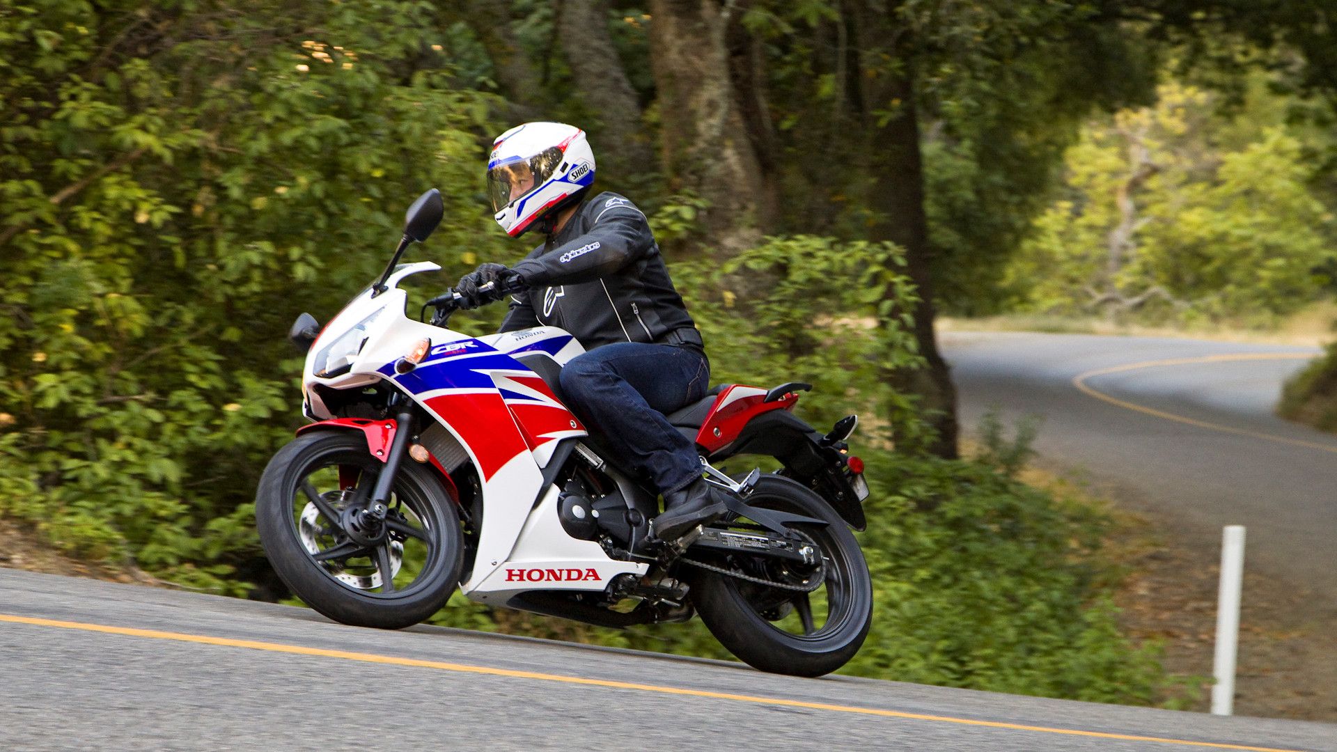 White 2015 Honda CBR300R coming our of a curve