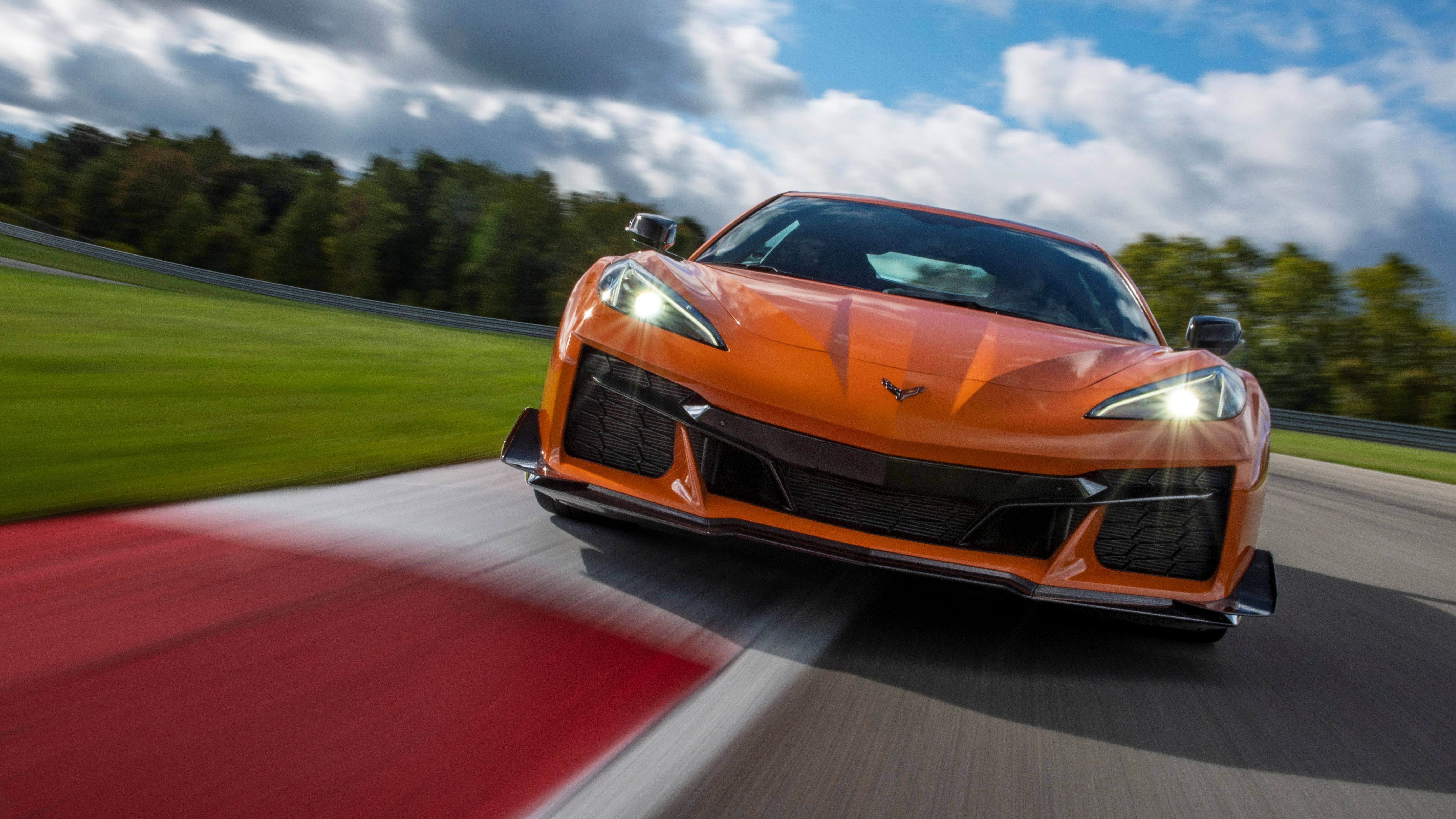 A front-on action shot of a 2023 Chevrolet Corvette C8 Z06 on a race track