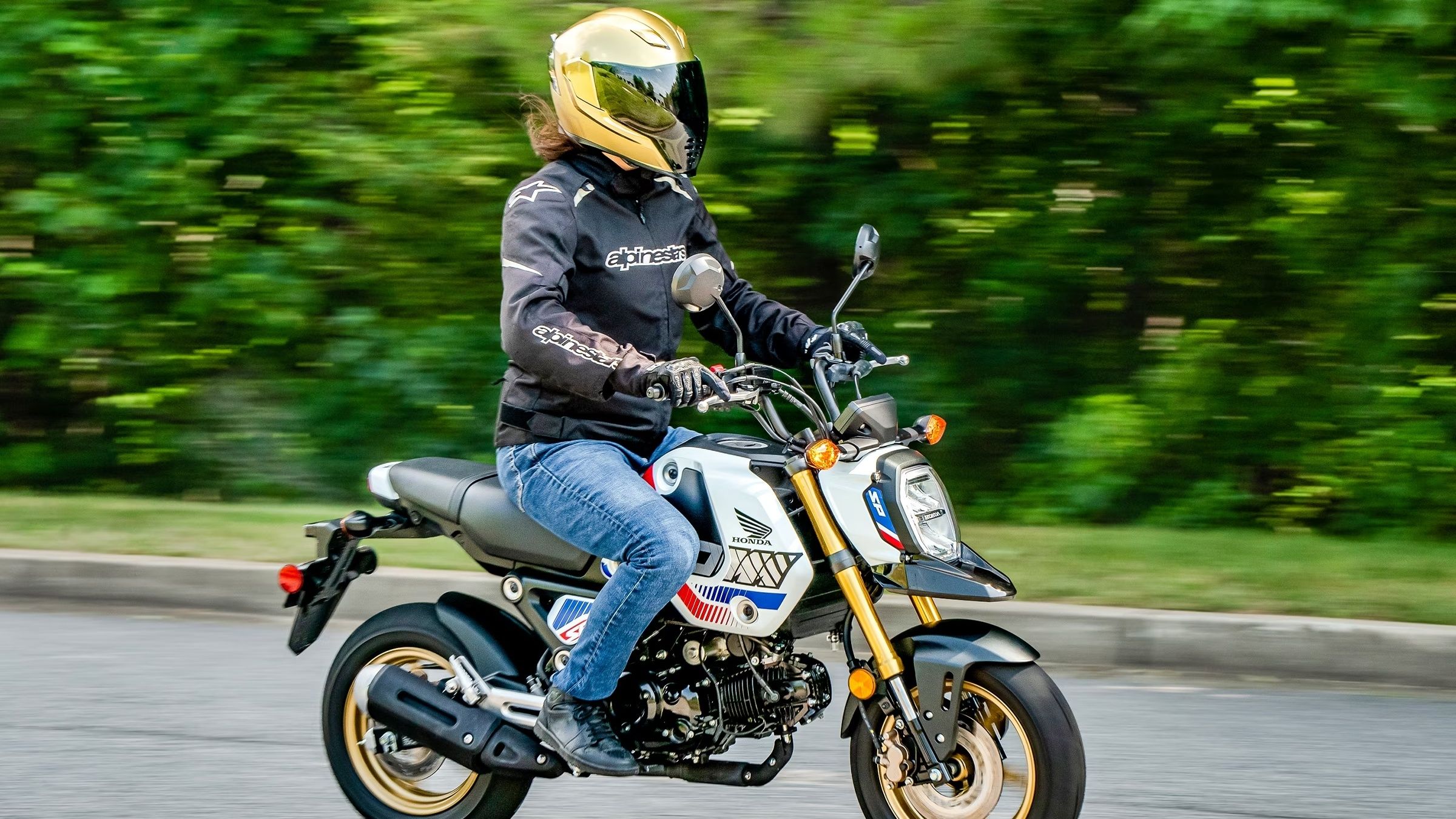 A side action shot of a 2023 Honda Grom ABS on the road