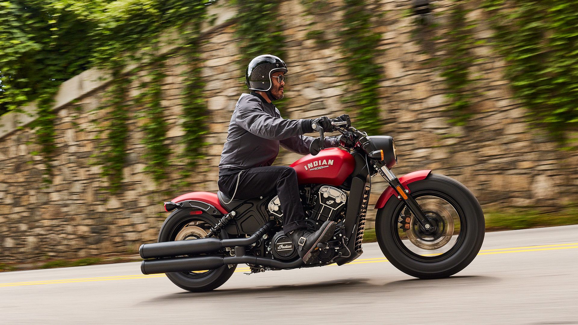 Red 2023 Indian Scout Bobber cruising on the road