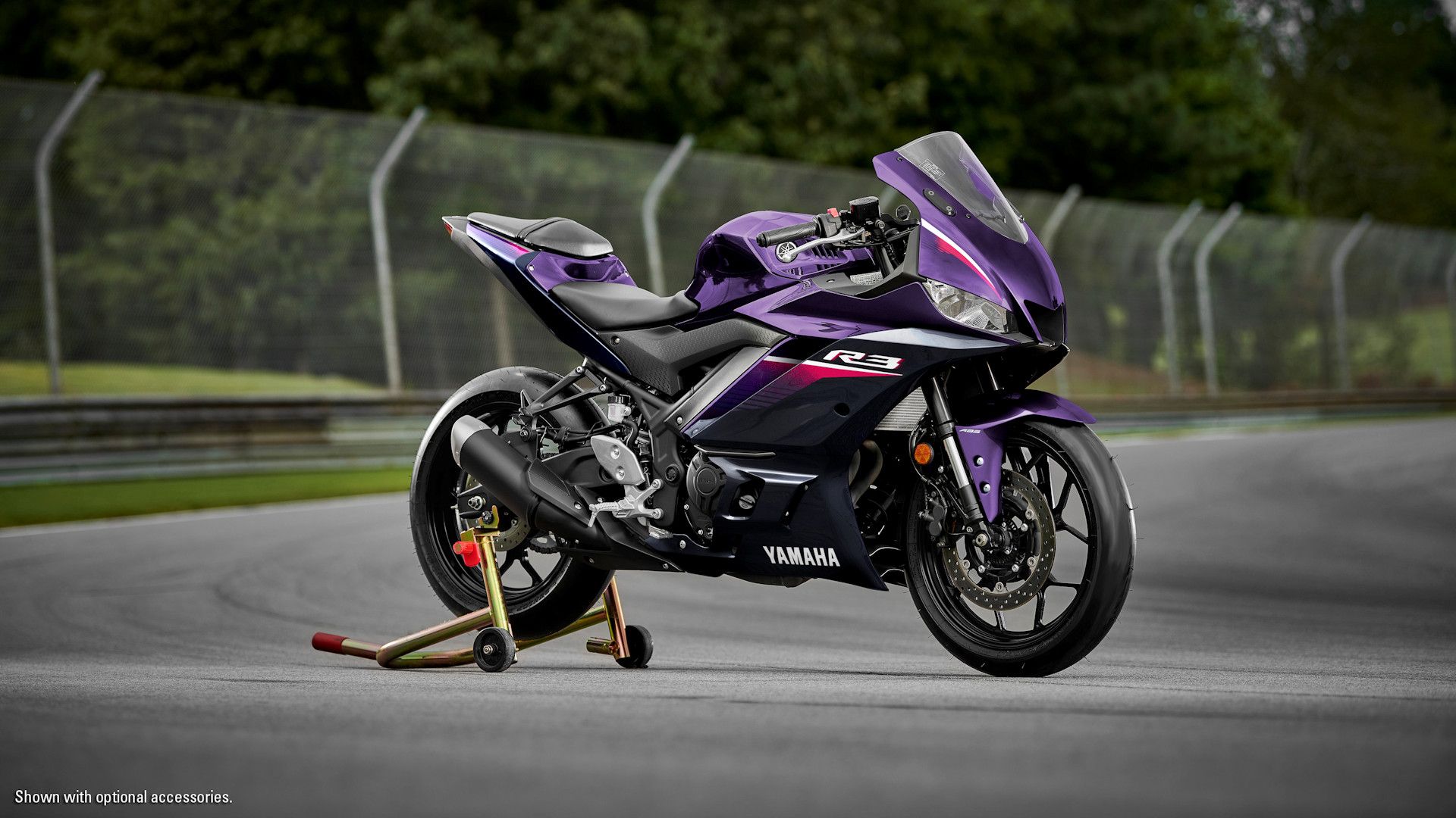Accessorized purple 2023 Yamaha YZF-R3 on the stand