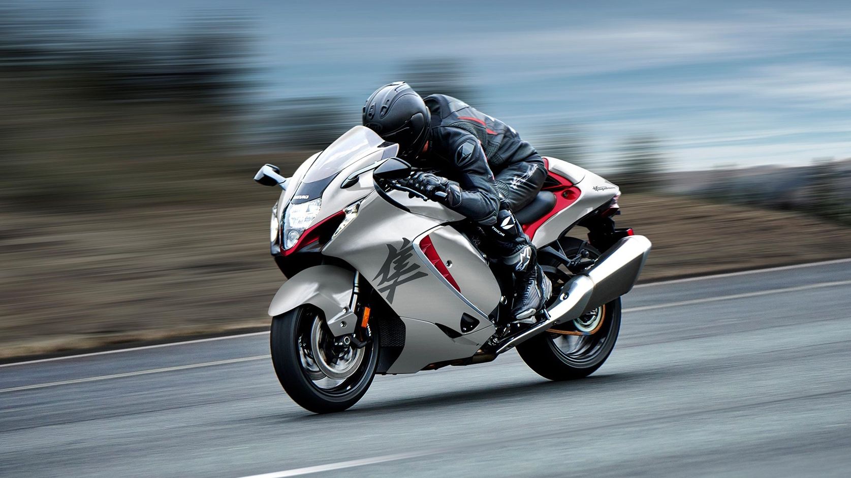 An action shot of a 2023 Suzuki Hayabusa riding on the road