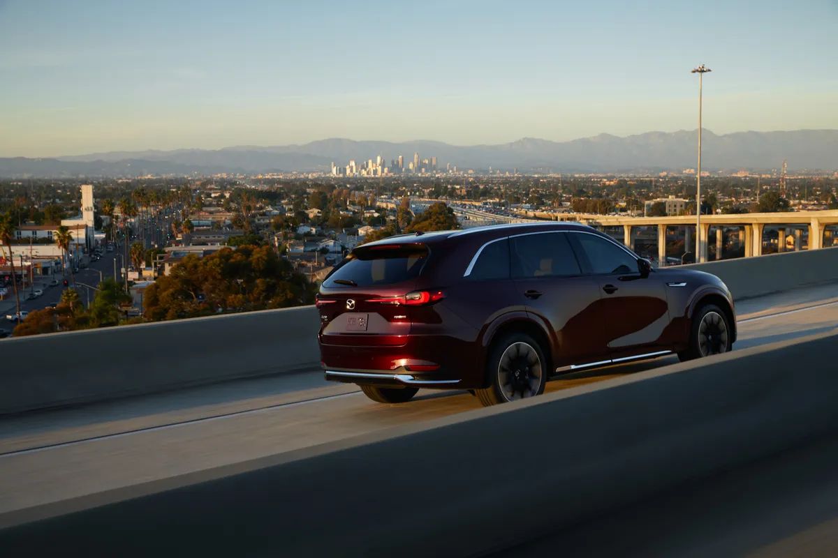 Burgundy Mazda CX-90 on bridge