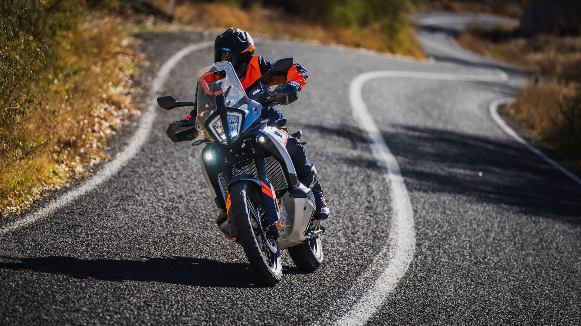 An action front shot of a 2023 KTM 790 ADVENTURE on a twisty road