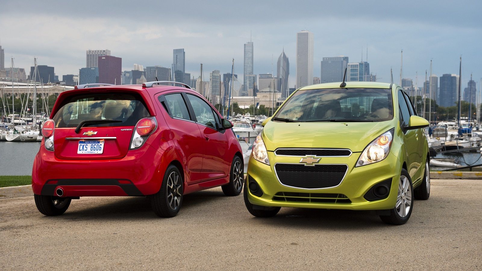 A couple of 2013 Chevrolet Sparks parked 