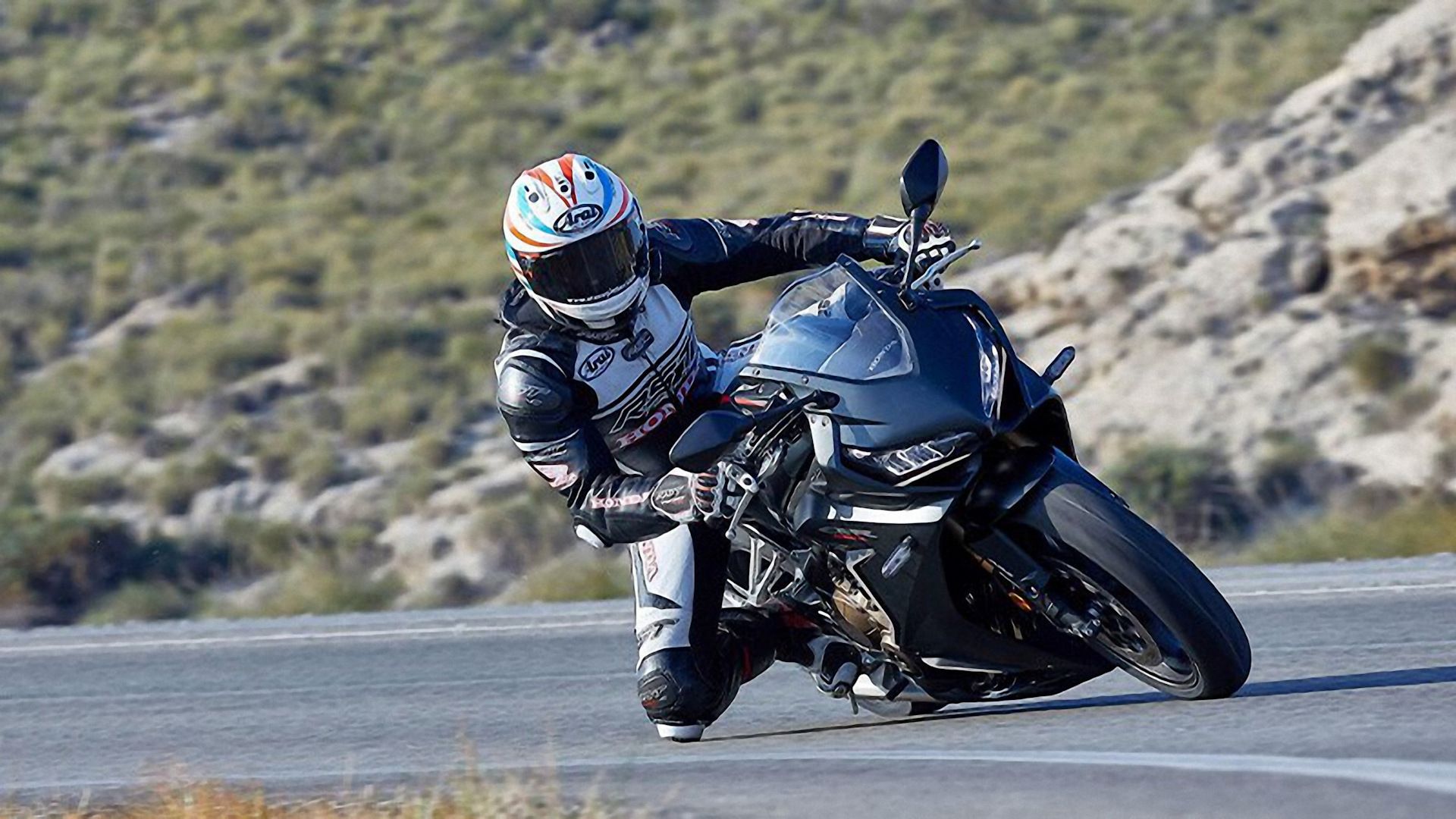 Black 2021 Honda CBR650R leaning into a curve