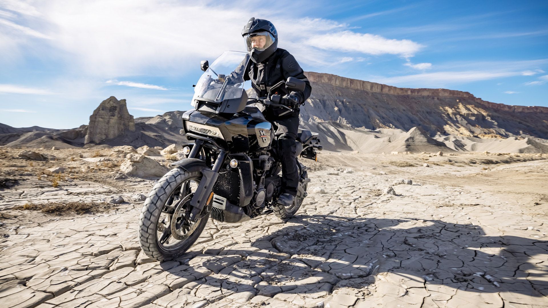 Black 2022 Harley-Davidson Pan America 1250 riding in the desert