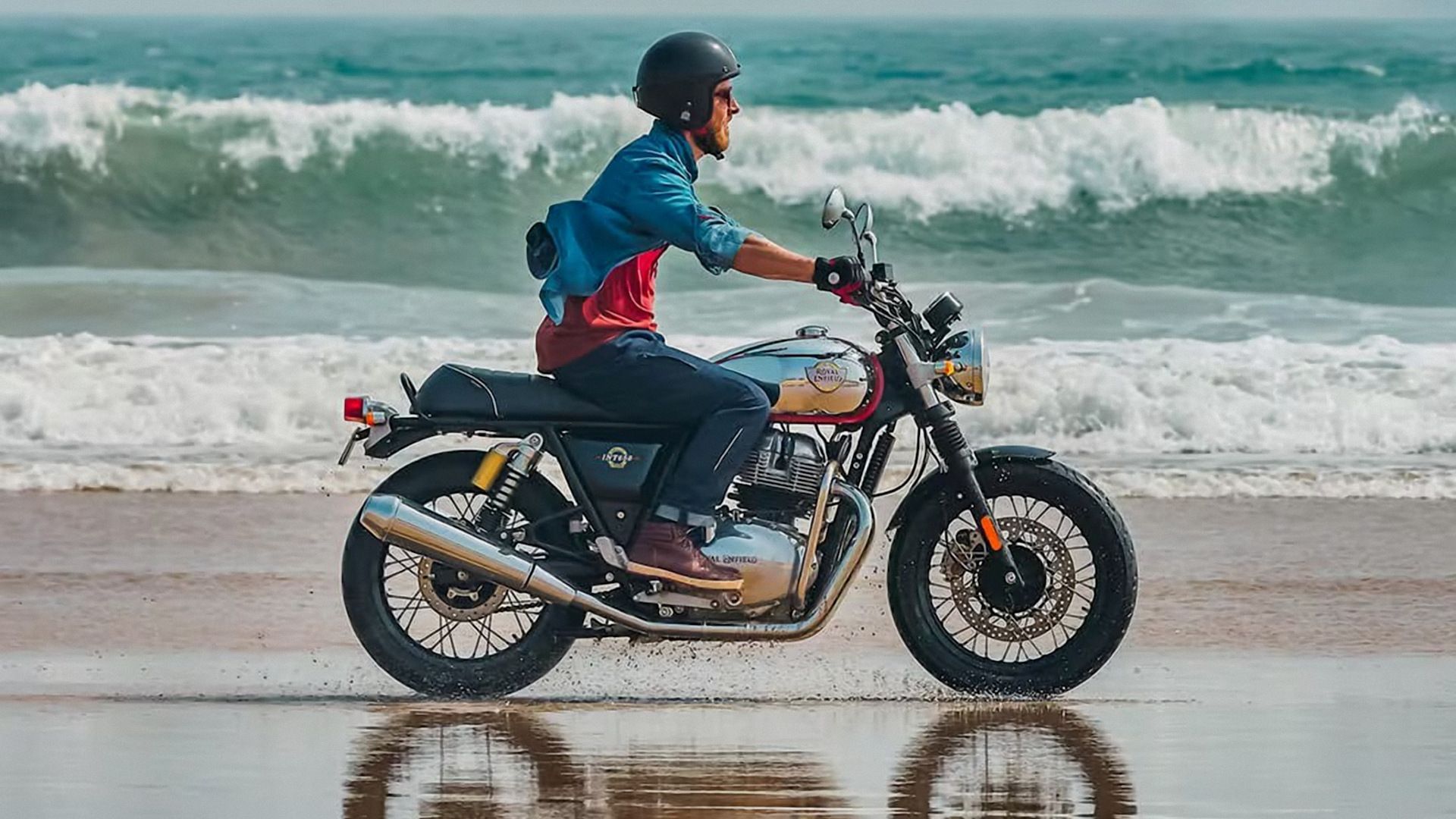 A 2022 Royal Enfield INT650 cruising on the beach