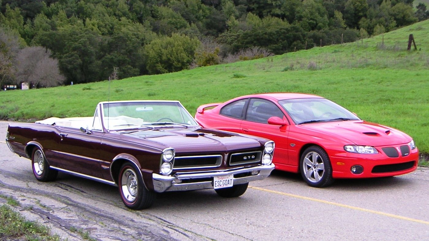 1965 Pontiac GTO convertible next to a 2005 Pontiac GTO