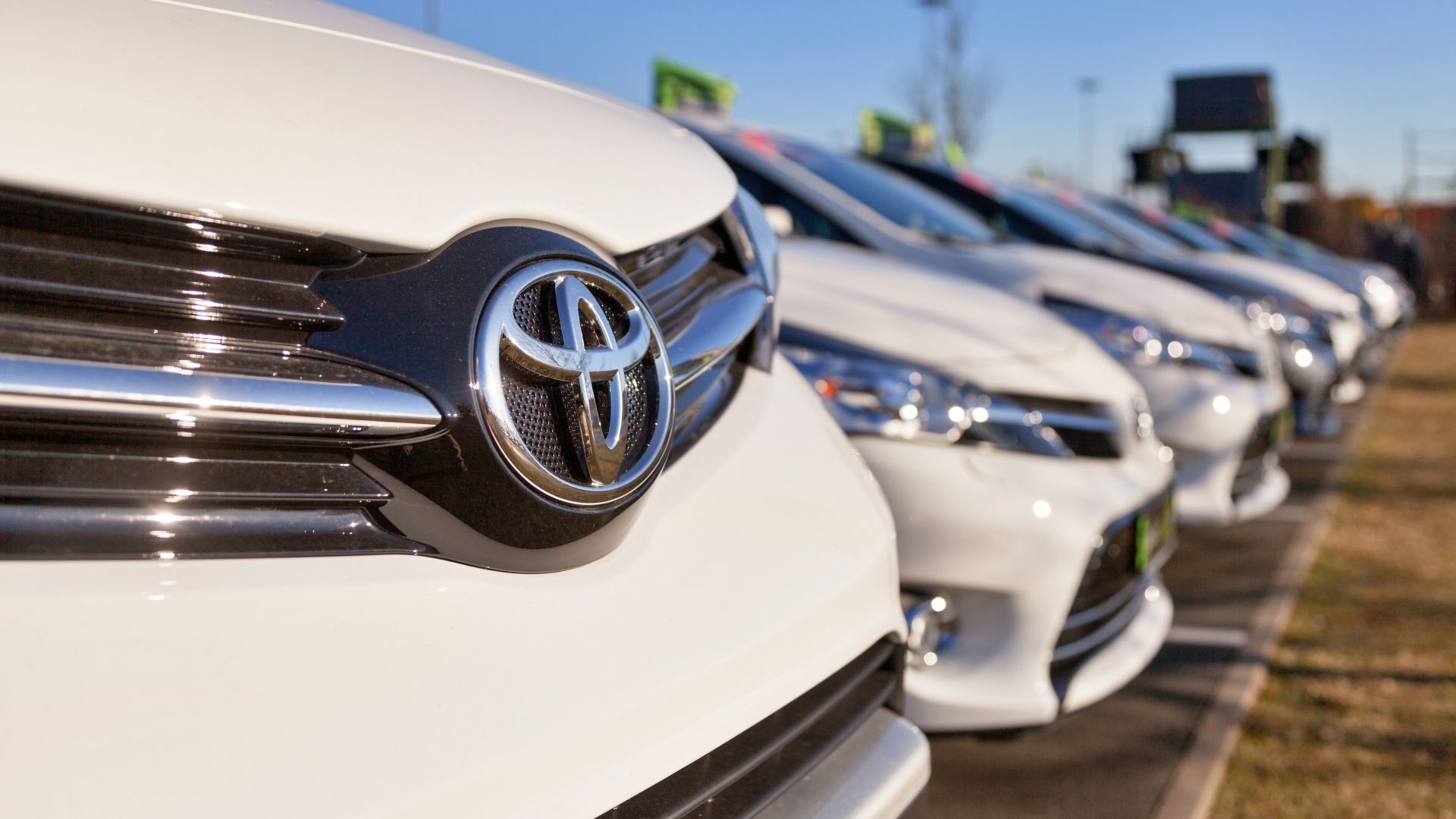 A fleet of white Toyota's at a dealership