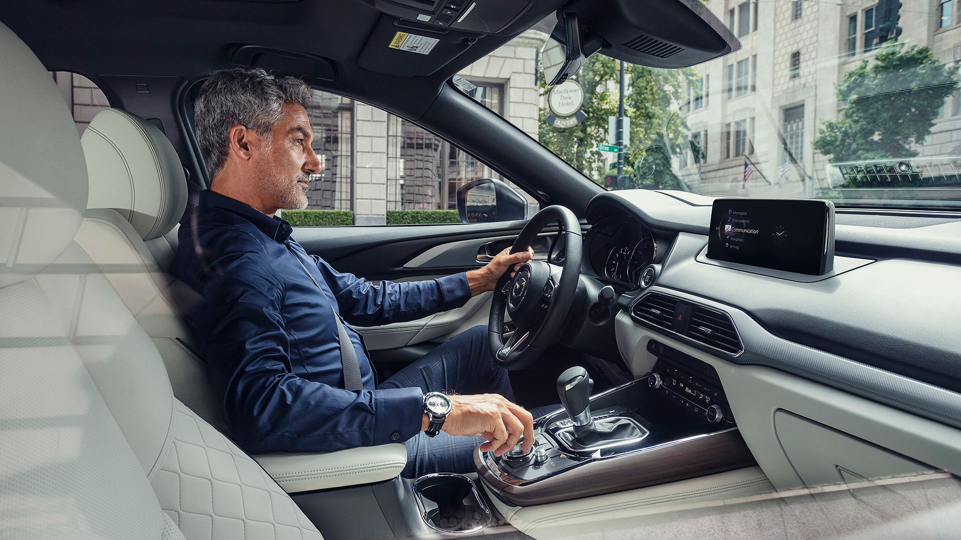 Interior of a 2023 Mazda CX-9 Signature with a driver behind the wheel