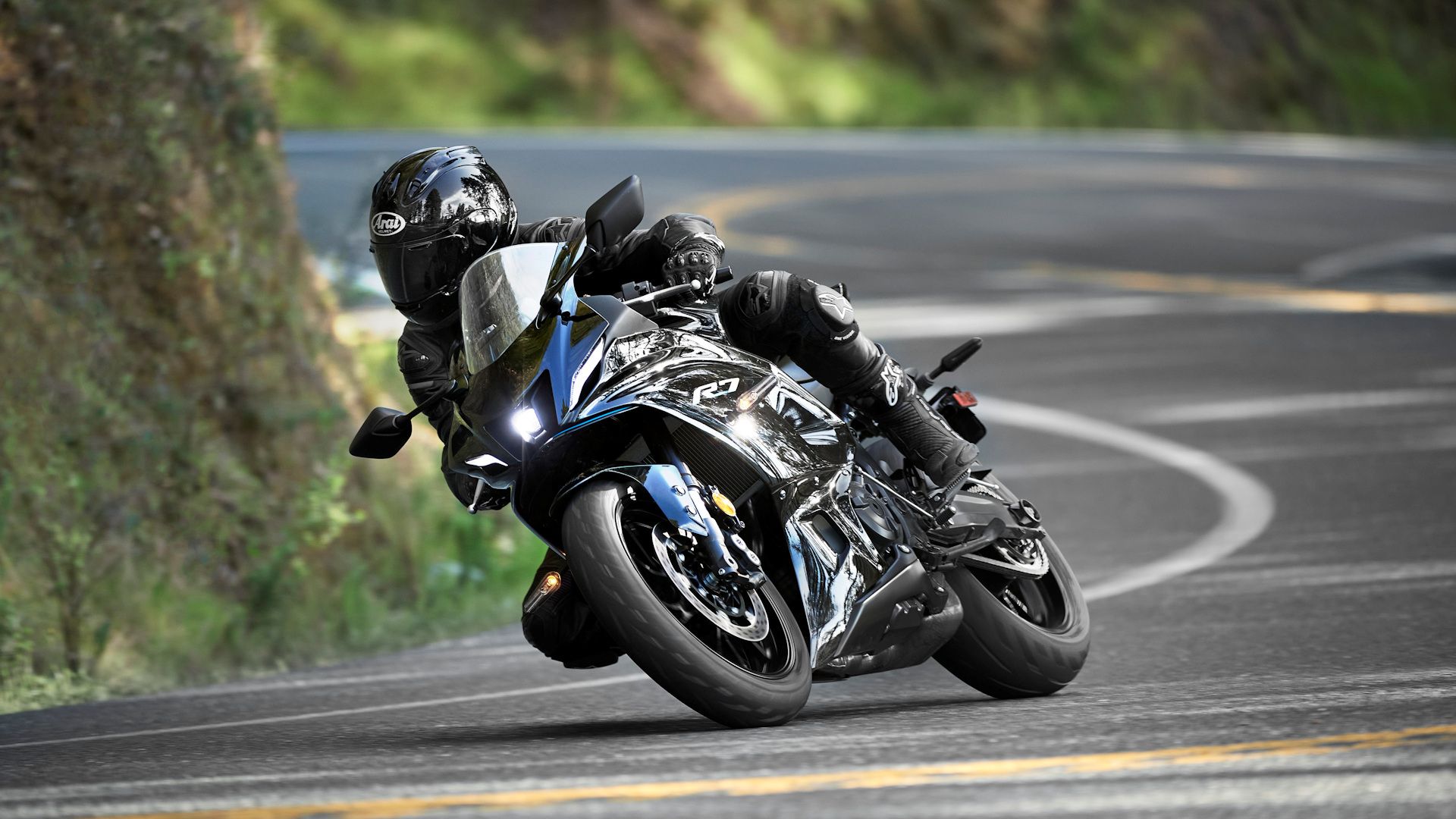 Black 2023 Yamaha YZF-R7 coming out of a curve