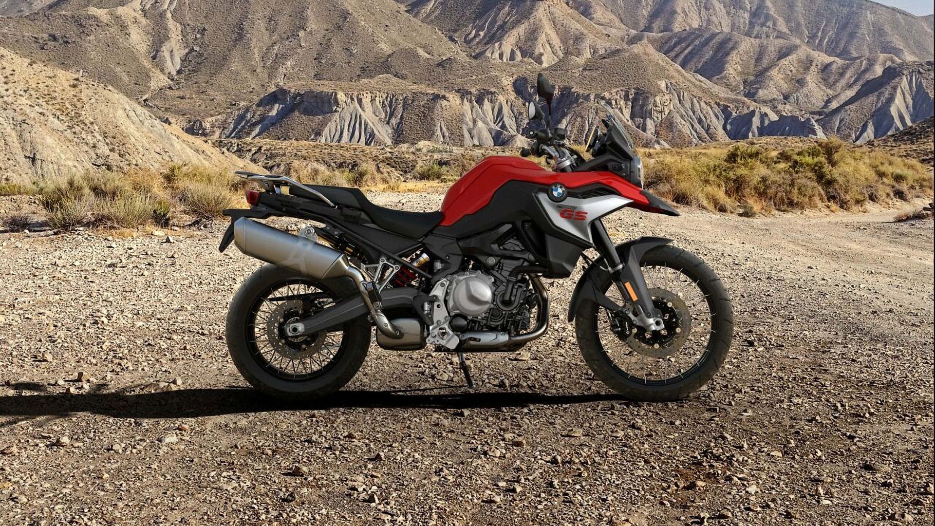 Red 2023 BMW F 850 GS parked at trailside