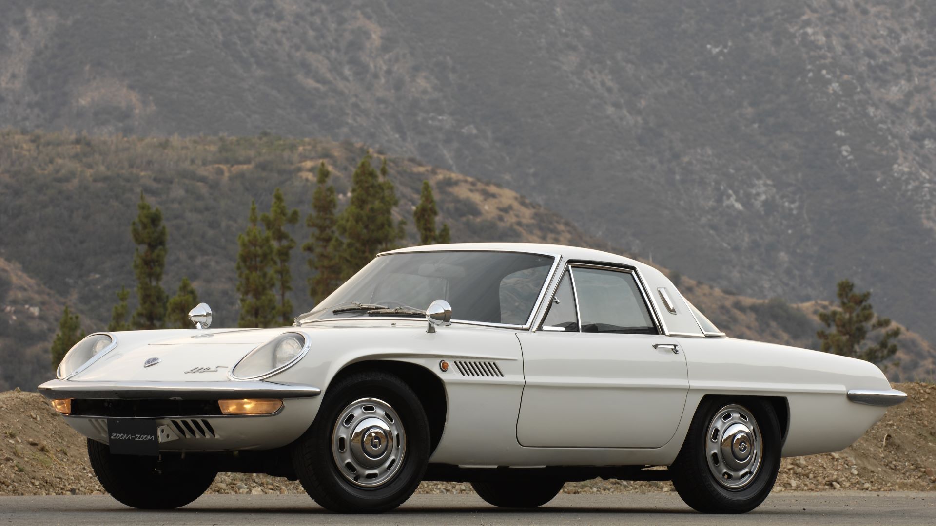 A front 3/4 shot of a 1967 Mazda Cosmo Sport 110S parked