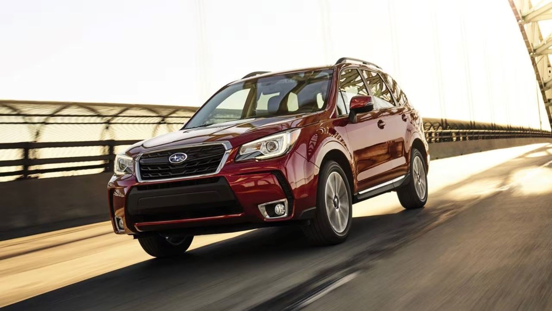 Front 3/4 shot of a red 2018 Subaru Forester 2.0 XT Touring cruising