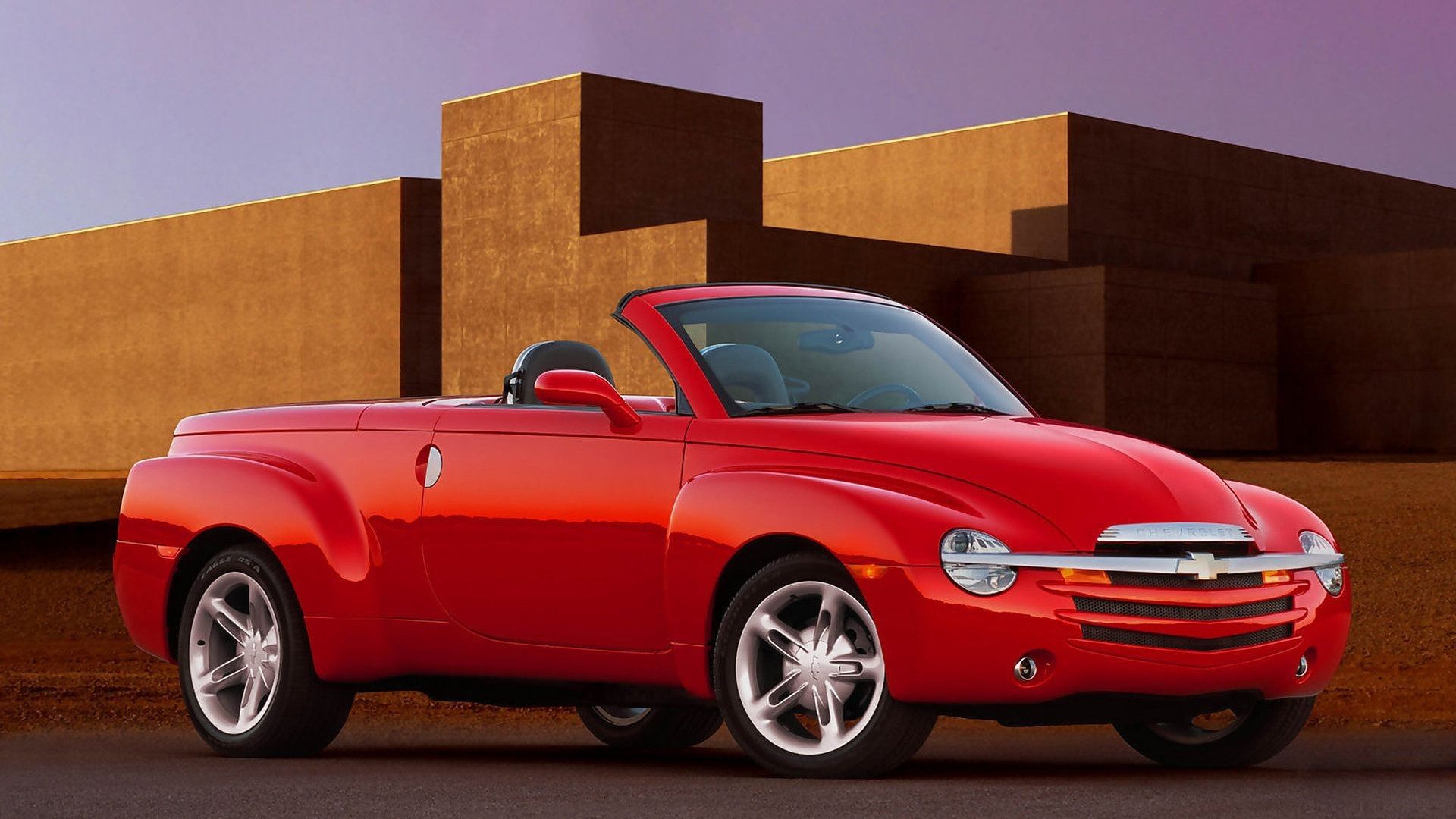 red 2003 Chevrolet SSR pickup with the roof down