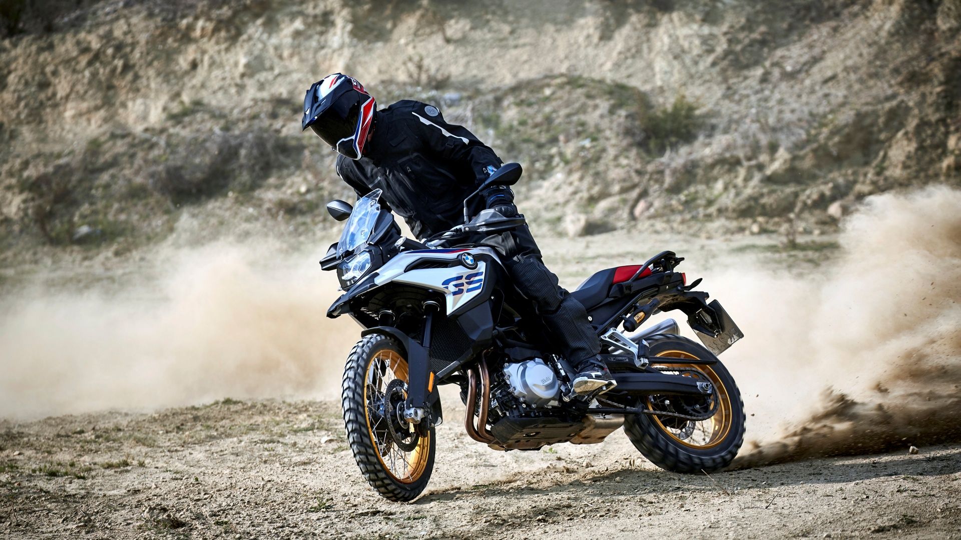 An action shot of a BMW F 850 GS riding off-road