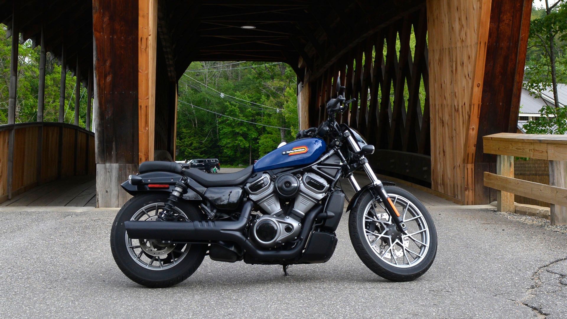 2023 Harley-Davidson Nightster Special parked near a covered bridge.