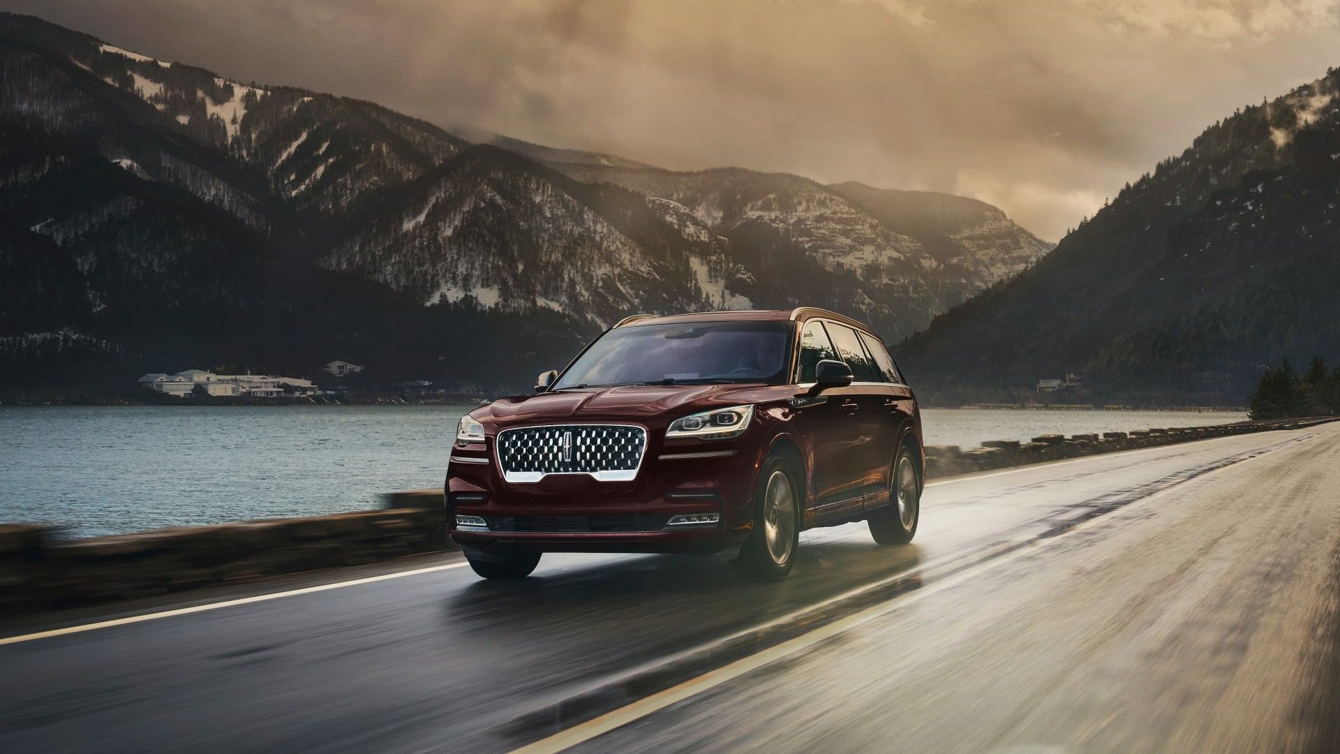 Front 3/4 shot of a The Lincoln Aviator Black Label cruising through mountainous road.