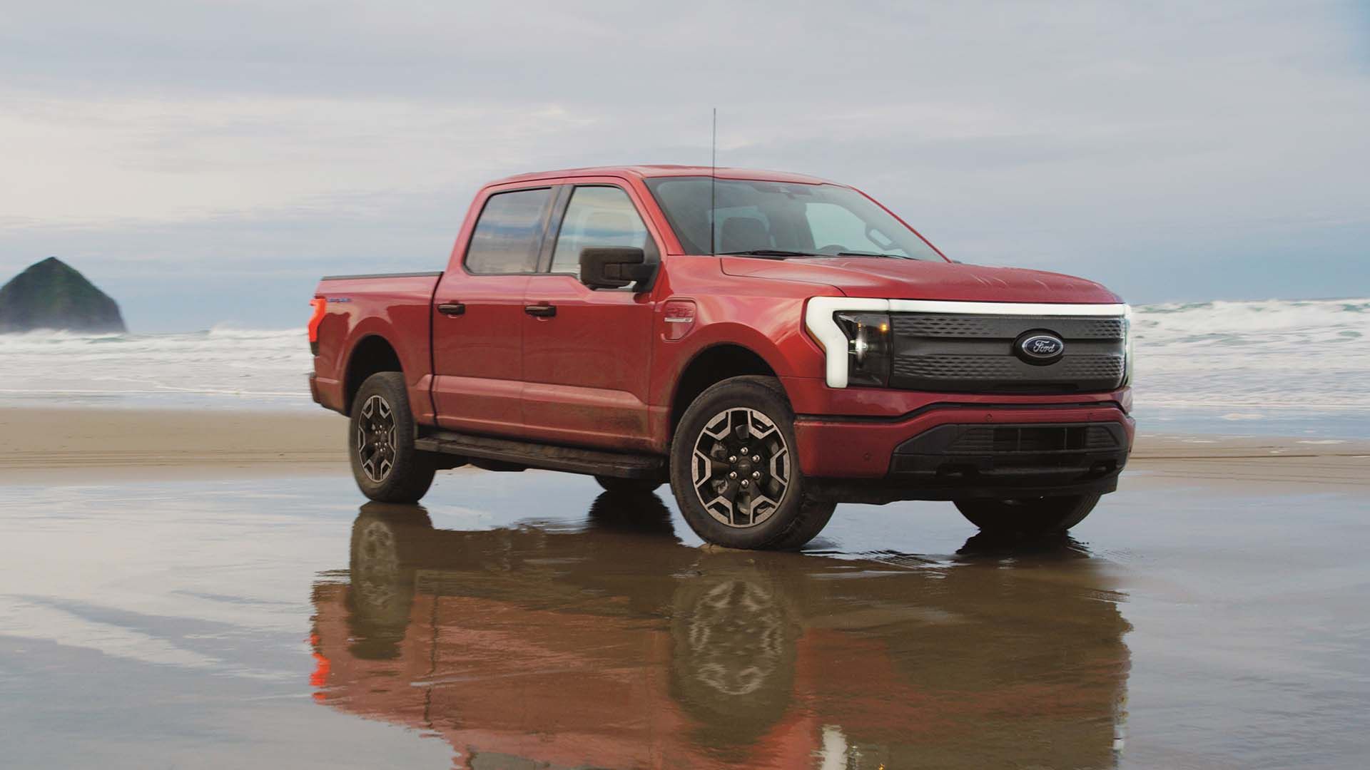 A Ford F-150 Lightning XLT at a beach