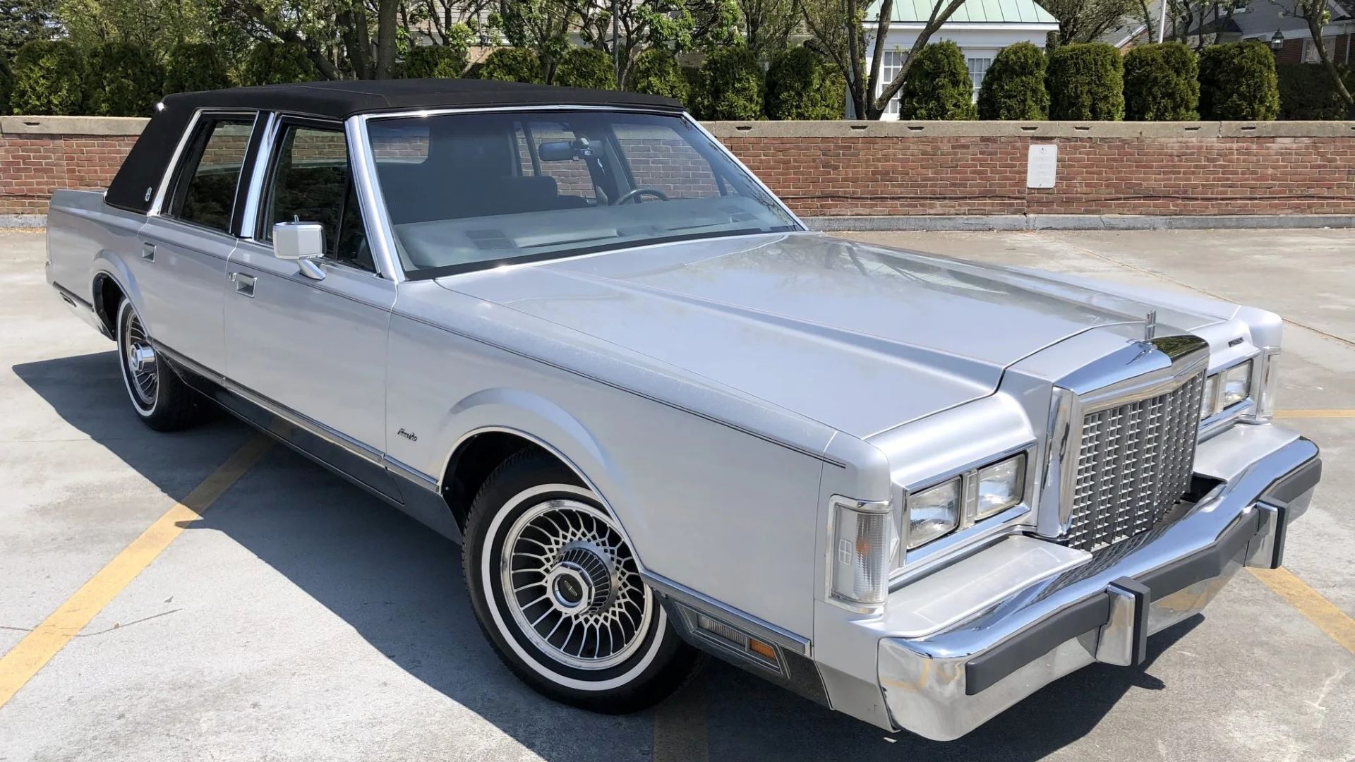 Front 3/4 shot of an 80s Lincoln Town Car parked